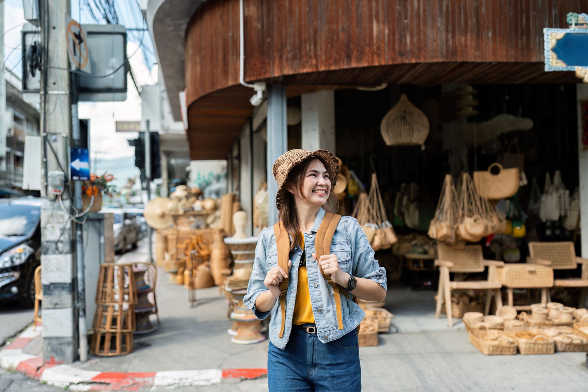 Young female tourist walking across the street in local market. travelling concept